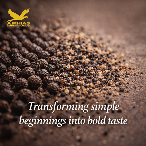 Freshly ground bold black pepper falling onto a seasoned steak, highlighting the large grain size and aromatic quality of premium whole peppercorns.