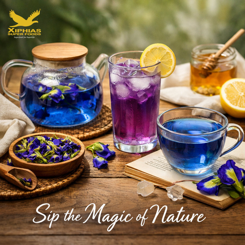 A clear glass cup of vivid blue butterfly pea tea with lemon and dried flowers on a rustic surface.